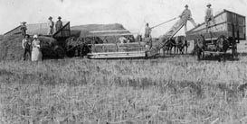 historic photo of farmers and equipment at harvest